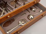 a wooden box with silverware in it on a table