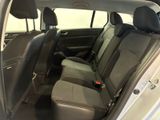 the back seats of a silver car with a black seat belt