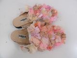 a pair of pink and white slippers on a white surface