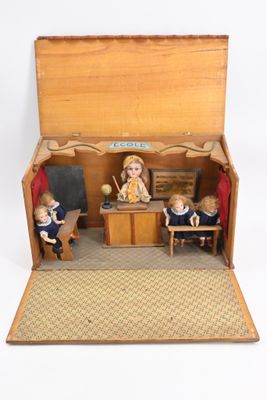 a small doll house with a teacher and two children in it