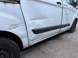 a white van that is parked on the side of the road
