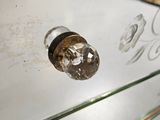 a close up of a glass drawer with a bottle on it