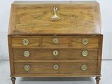 an old wooden desk with drawers and brass hardware on it