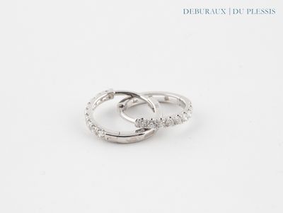 a close up of two wedding rings on a white surface