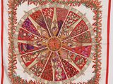 a red and white scarf with a circular design on it