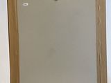 a wooden easel with a mirror on top of it in front of a white background