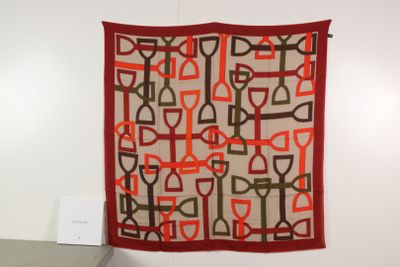 a wall hanging with a red and brown design on it