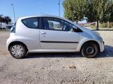 a small white car parked on the side of the road