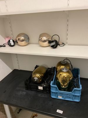 a shelf that has a bunch of gold helmets on it