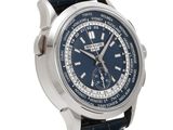 a close up of a watch on a white background with a blue dial