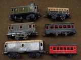 several toy trains are lined up on a brown surface