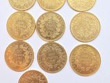 six different types of gold coins on a white surface