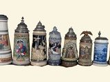 many different types of beer mugs lined up on a table
