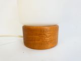 a lamp that is sitting on a wooden stand