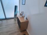 a bathroom with a scale on the floor in front of a window
