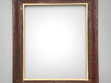 a wooden frame with a white background on a gray wall
