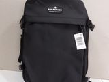 the back of a black backpack sitting on top of a white table