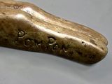 a bronze shoe that is sitting on a table
