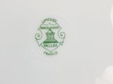 an image of a white plate with a green emblem on it
