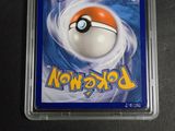 a pokemon card in a plastic container on a table