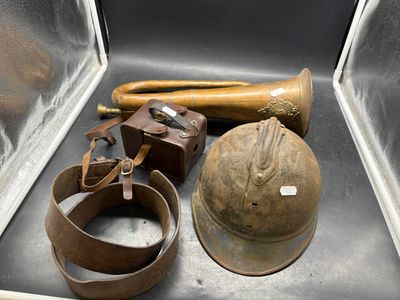 a metal box with a helmet, a baseball bat, and other items in it