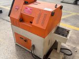 an orange and white machine sitting on top of a cement floor