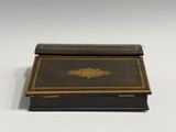 a black box with a gold decoration on it