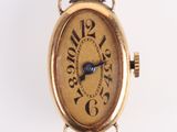 an image of a small gold wrist watch with a blue second hand