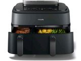 philips air fryer with vegetables and meat in it on a white background