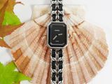 black and silver watch on a black and white chain bracelet