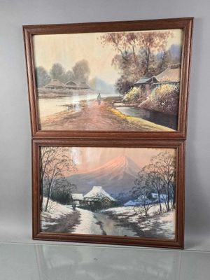 two framed paintings of a mountain scene with a river in the foreground