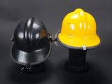 two yellow and black hard hats sitting next to each other on a black surface