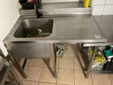 a stainless steel sink in a kitchen next to a counter