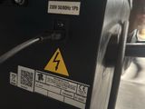 a close up of a black electrical box with a yellow sign on it