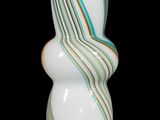 a white vase with a green and orange swirl on it