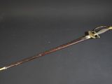 a close up of a sword on a table with a black background
