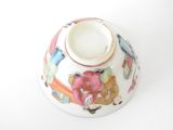 a small white bowl with a colorful design on it