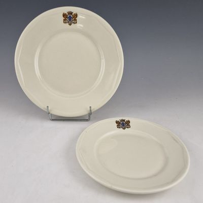 two white plates with blue and gold designs on them