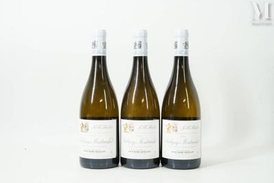 three bottles of wine sitting on top of a white table