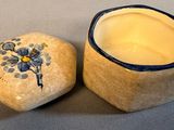 a small box with a flower painted on it