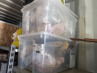 two plastic containers sitting next to each other on a shelf