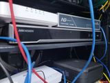 a rack with a lot of wires and a laptop on it