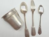 a silverware set on a white table with a cup and spoon