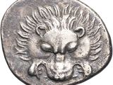 a close up of a silver coin with a lion head on it