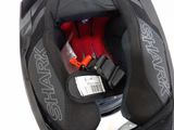a black helmet with a red seat belt and a black helmet with a red seat belt and a black helmet with a red seat belt