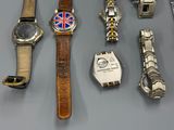 many different types of watches on display on a table