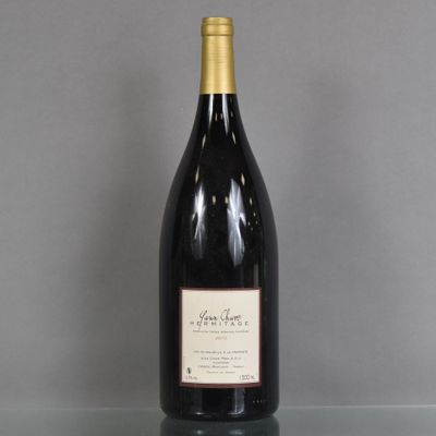 a bottle of wine sitting on top of a glass table