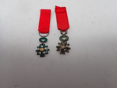 two medals with a red ribbon and a cross on them