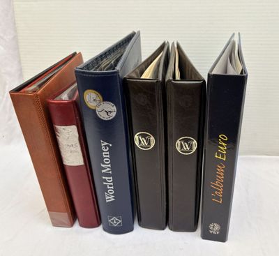 four books are lined up in a row on a white surface