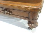 a wooden table with a drawer on top of it